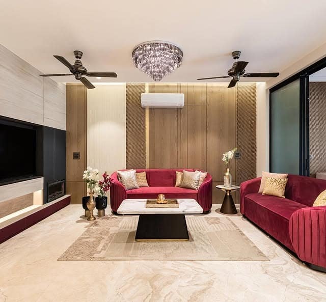 18. Burgundy and Black Living Room with Gold Detailing - black and gold living room ideas