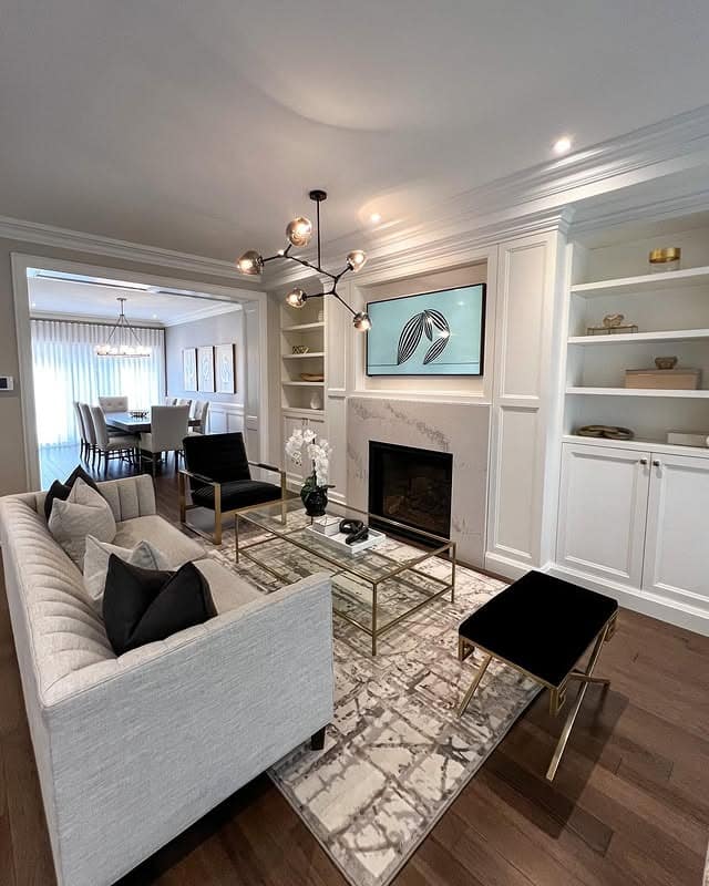 19. Transitional Black, White, and Gold Living Room - black and gold living room ideas