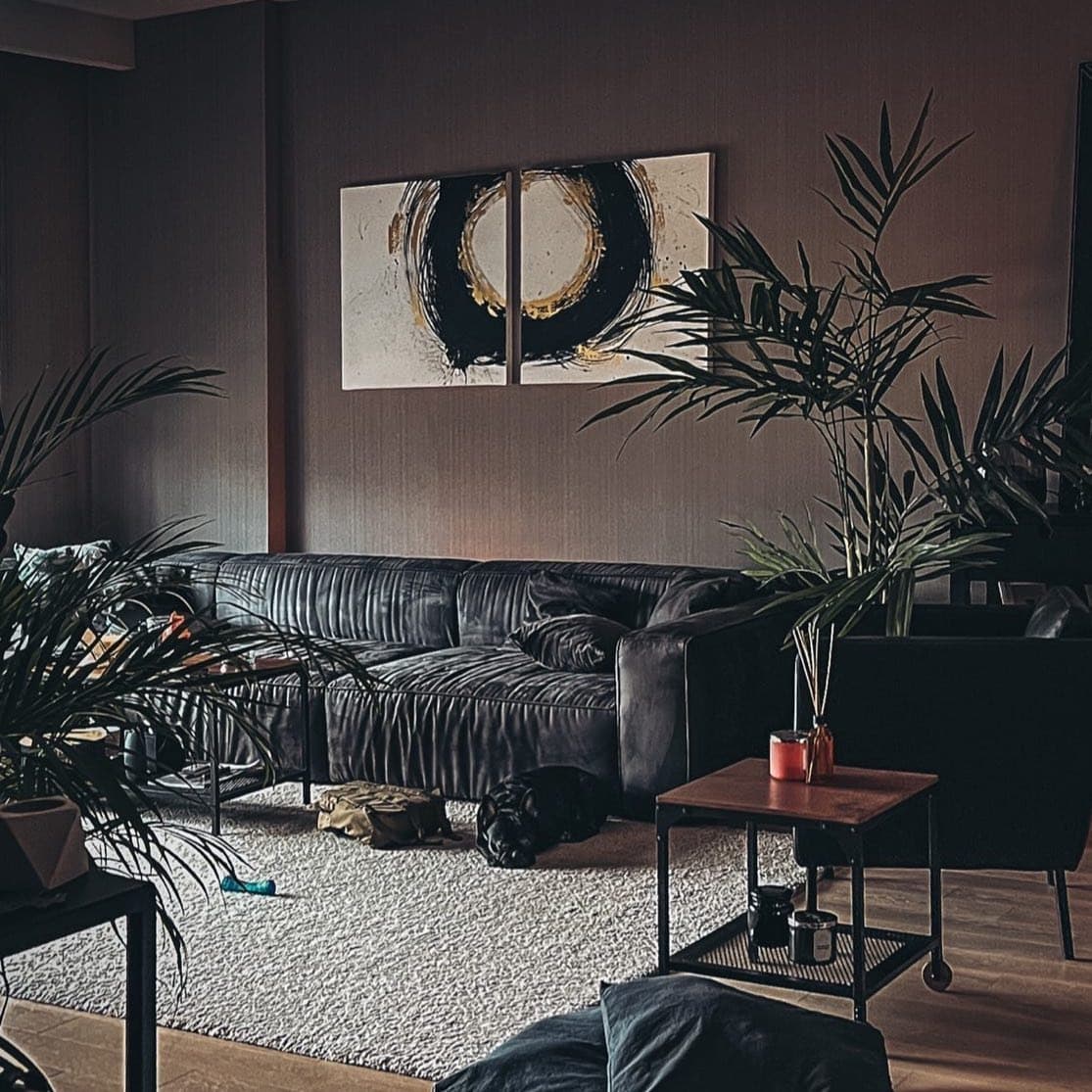 20. Moody Black Living Room with Gold Abstract Art - black and gold living room ideas