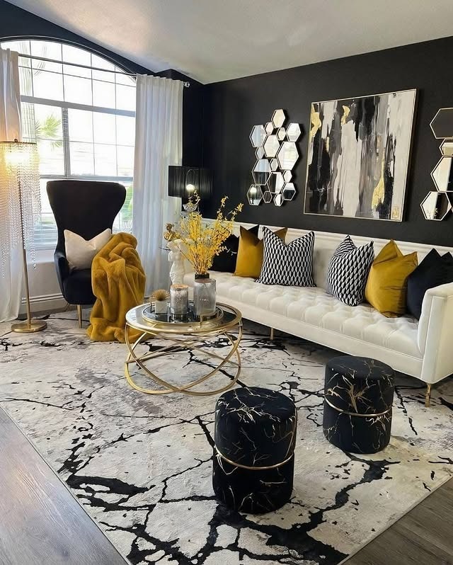 21. Modern Black and Gold Living Room with White Sofa Contrast - black and gold living room ideas