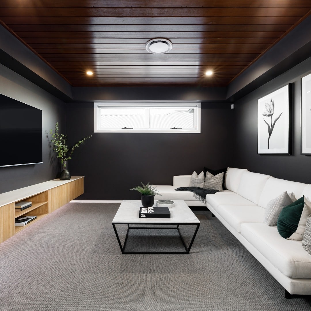 7. Black Basement Living Room with Warm Wood Ceiling - black living room ideas