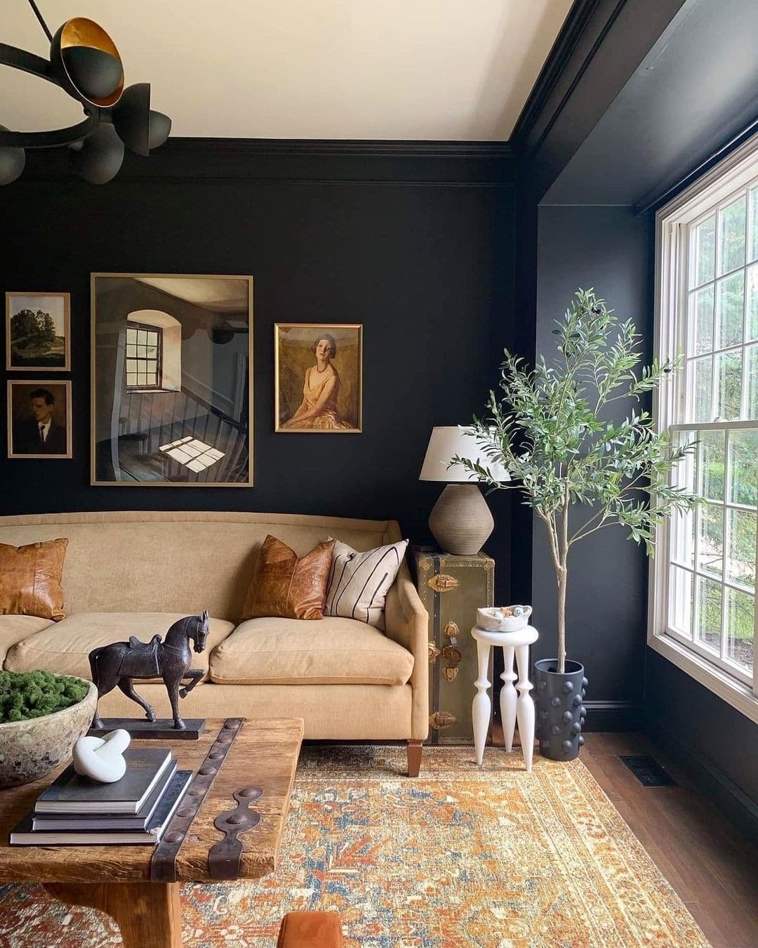 14. Classic Black Living Room with Traditional Artwork - black living room ideas
