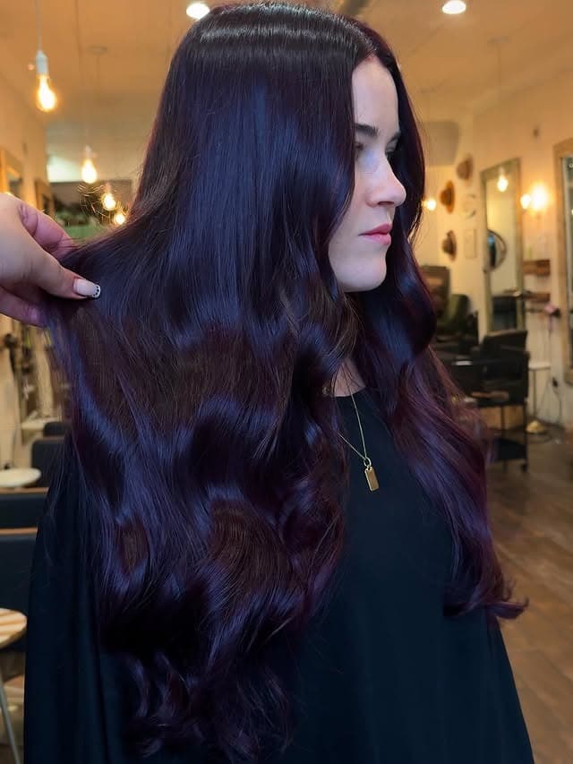 12. Glossy Burgundy Waves with Soft Dimension - Burgundy Hair Color