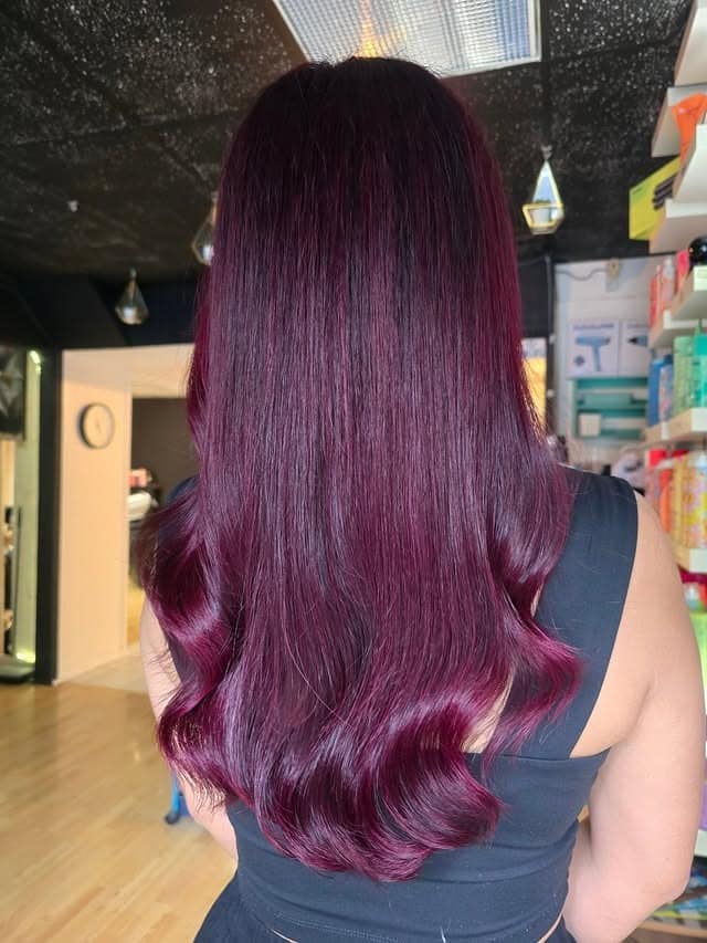 22. Sleek Long Burgundy Finish with Polished Waves - Burgundy Hair Color