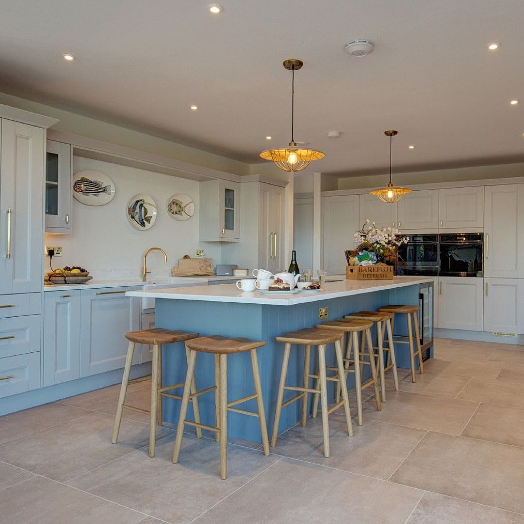 5. Painted Island with Seating in Soft Blue and Linen White - rustic kitchen island ideas