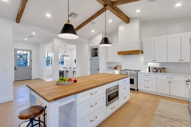17. Modern Farmhouse Island in Butcher Block and Bright White - rustic kitchen island ideas