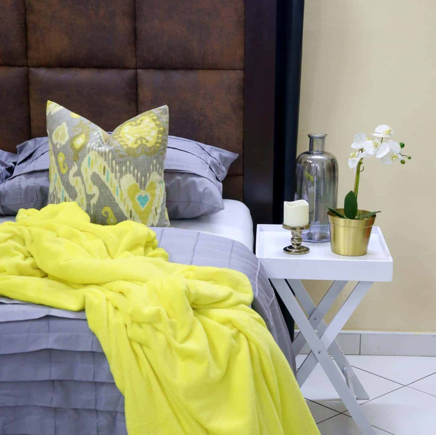 11. Soft Gray Bedroom with Bright Yellow Throw Accent - yellow and gray bedroom ideas