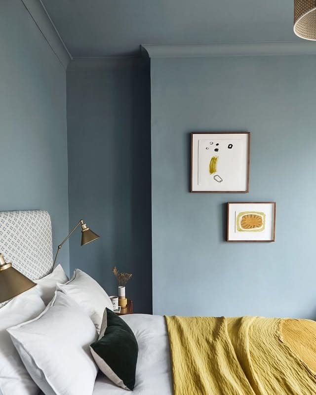 21. Muted Blue-Gray Bedroom with Soft Yellow Layering - yellow and gray bedroom ideas