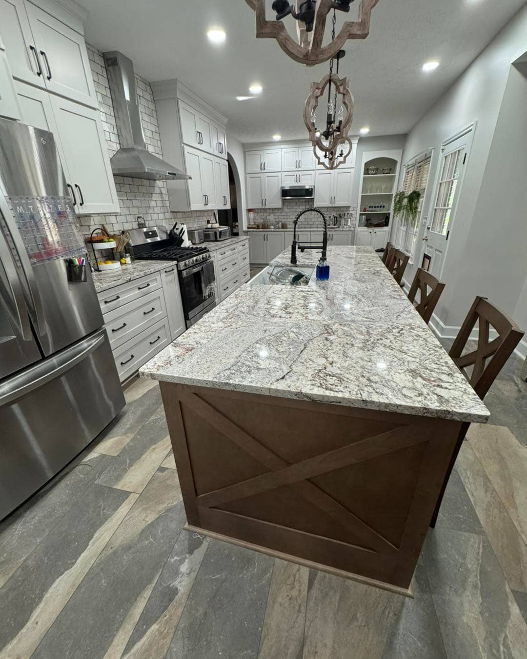 5. Textured Granite Island with Rustic Wood Base - granite countertops kitchen ideas