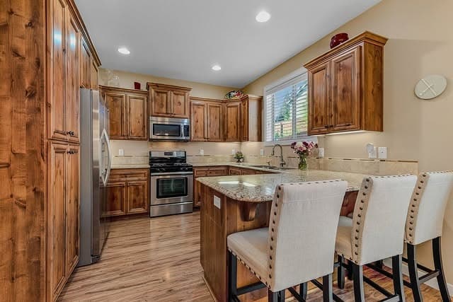 7. Traditional Wood Cabinetry with Neutral Granite - granite countertops kitchen ideas