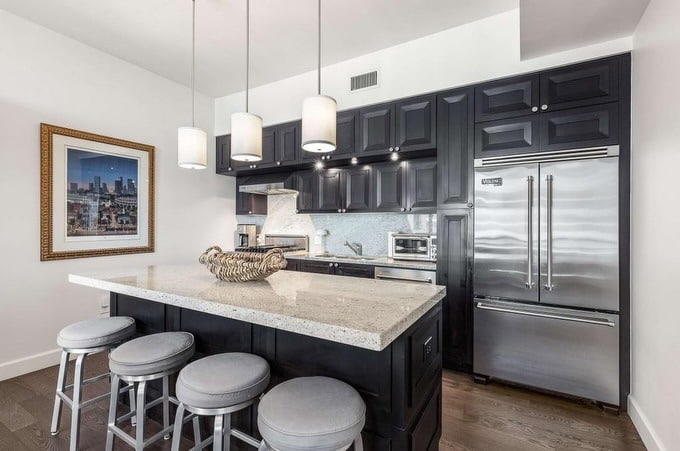 10. Contemporary Granite with Sleek Black Cabinetry - granite countertops kitchen ideas