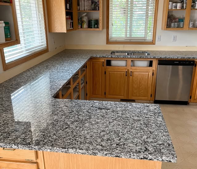 16. Speckled Granite with Classic Wood Cabinets - granite countertops kitchen ideas