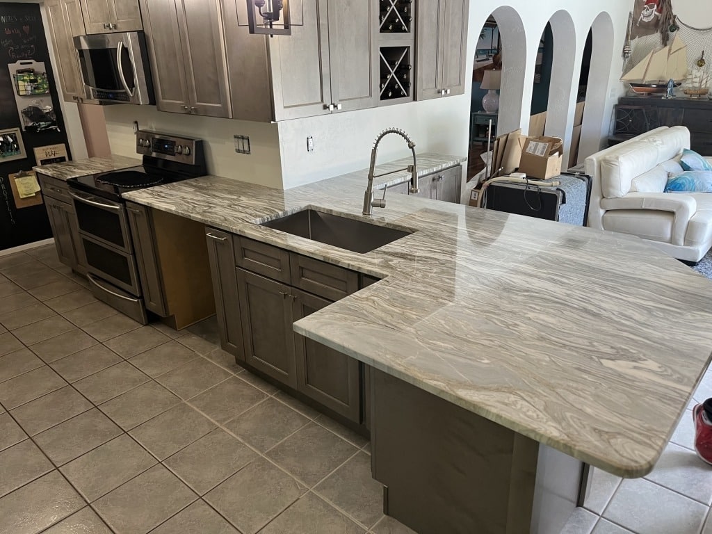 20. Layered Granite with Coordinated Backsplash - granite countertops kitchen ideas