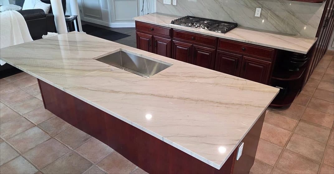 21. Cream Granite Island with Rich Cherry Cabinetry - granite countertops kitchen ideas