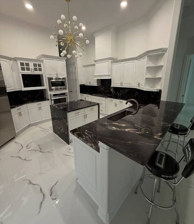22. Black Granite Countertops in a Luxe White Kitchen - granite countertops kitchen ideas