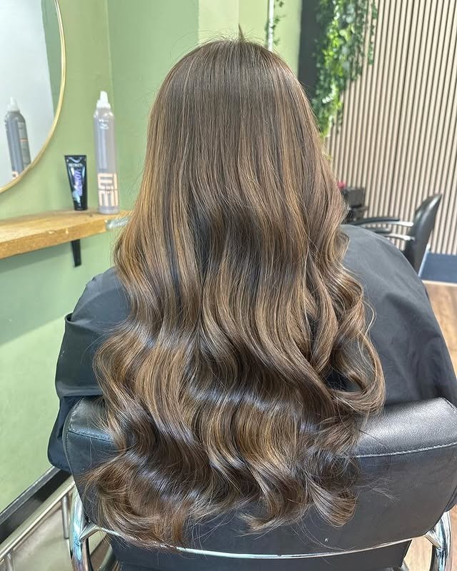 2. Rich Chocolate Brown Blowout with Warm Face-Framing Highlights - Chocolate Brown Hair with Highlights