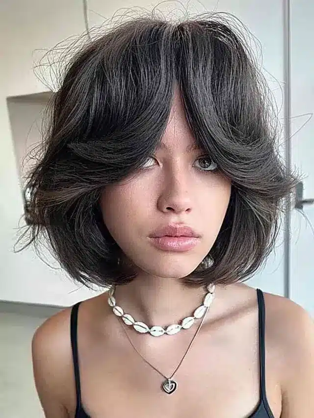 10. Sculpted French Bob with Voluminous Bangs in Deep Brown - Short Layered Haircuts with Bangs