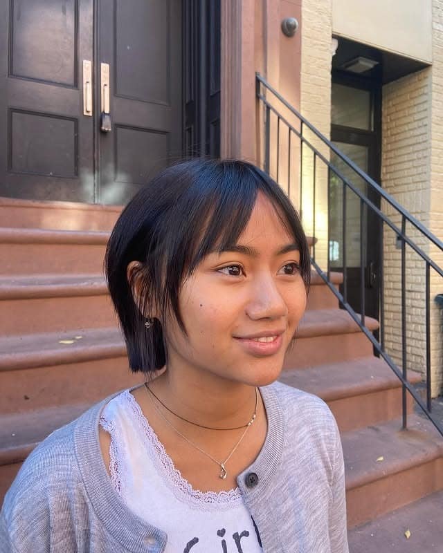 21. Sleek Short Bob with Soft Bangs in Natural Black - Short Layered Haircuts with Bangs