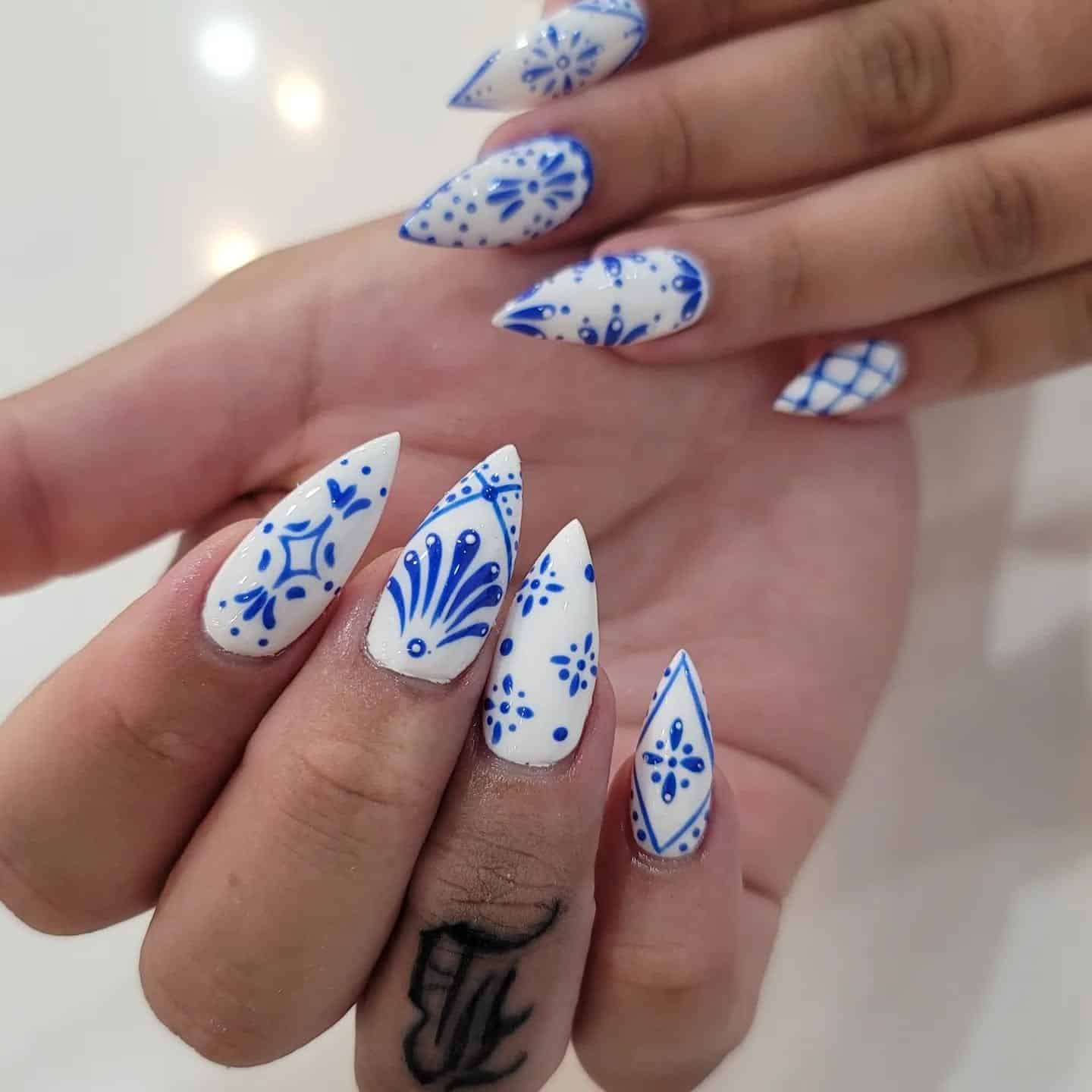 5. Hand-Painted Folk Art Stiletto Nails - white and blue nail ideas