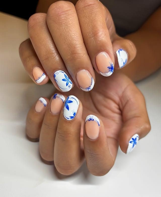 9. Blue Botanical Short Almond Nails - white and blue nail ideas