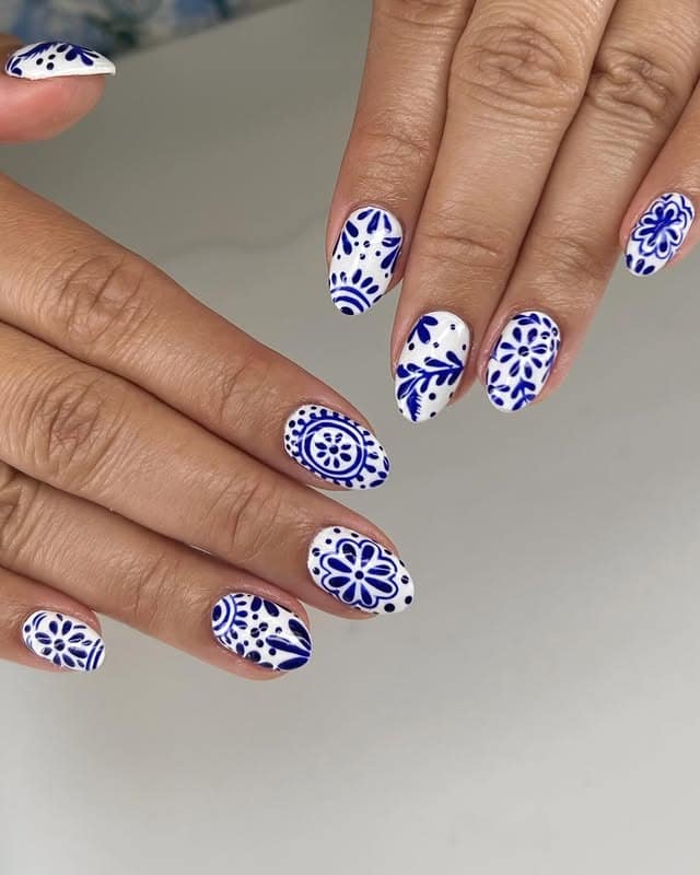 10. Ornamental Blue Mandala Almond Nails - white and blue nail ideas