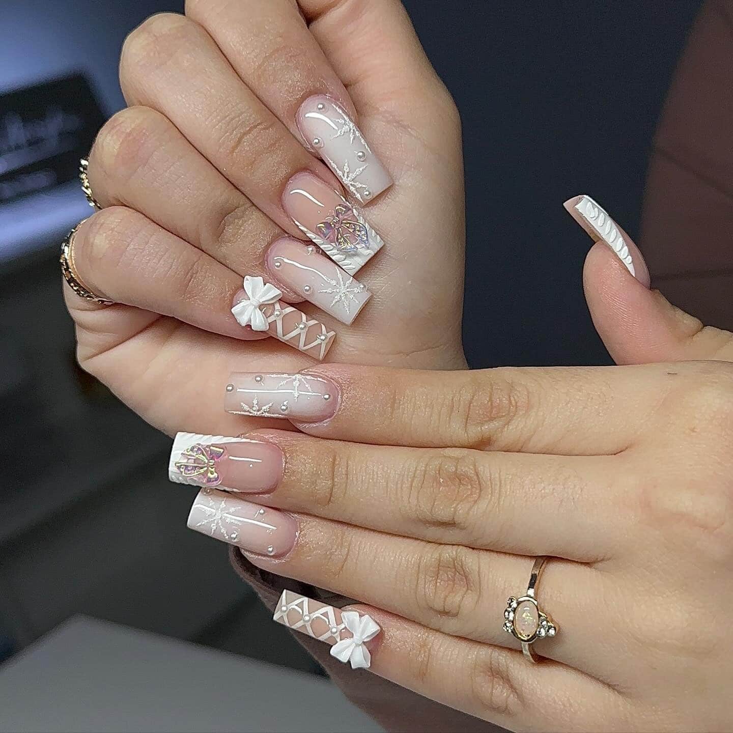 1. Pearl Bow Winter Elegance - white christmas nail ideas
