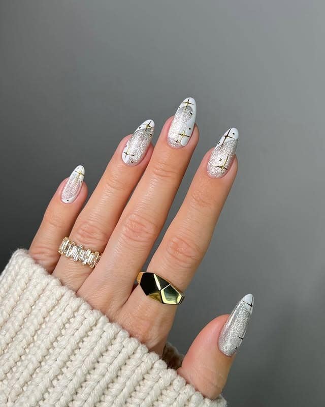 4. Metallic Snowflake Almond Nails - white christmas nail ideas
