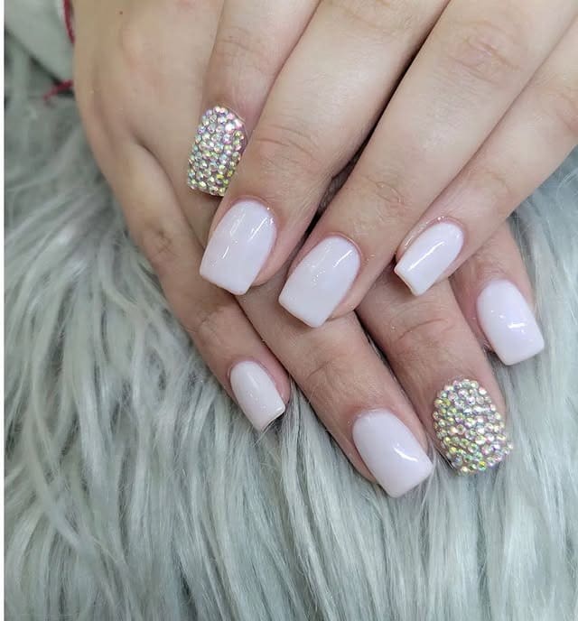 10. Minimal White with Crystal Accent Nails - white christmas nail ideas