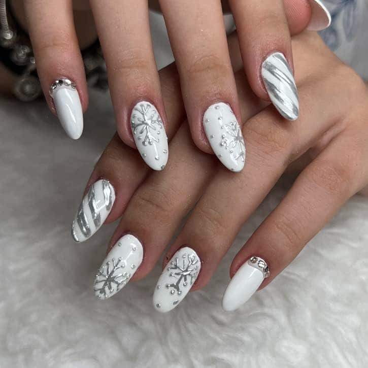 21. White Snowflake and Silver Swirl Almond Nails - white christmas nail ideas