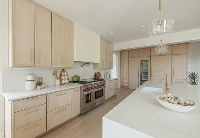 15. Light Oak Kitchen with Cream Surfaces and Brass Accents - oak cabinets kitchen ideas