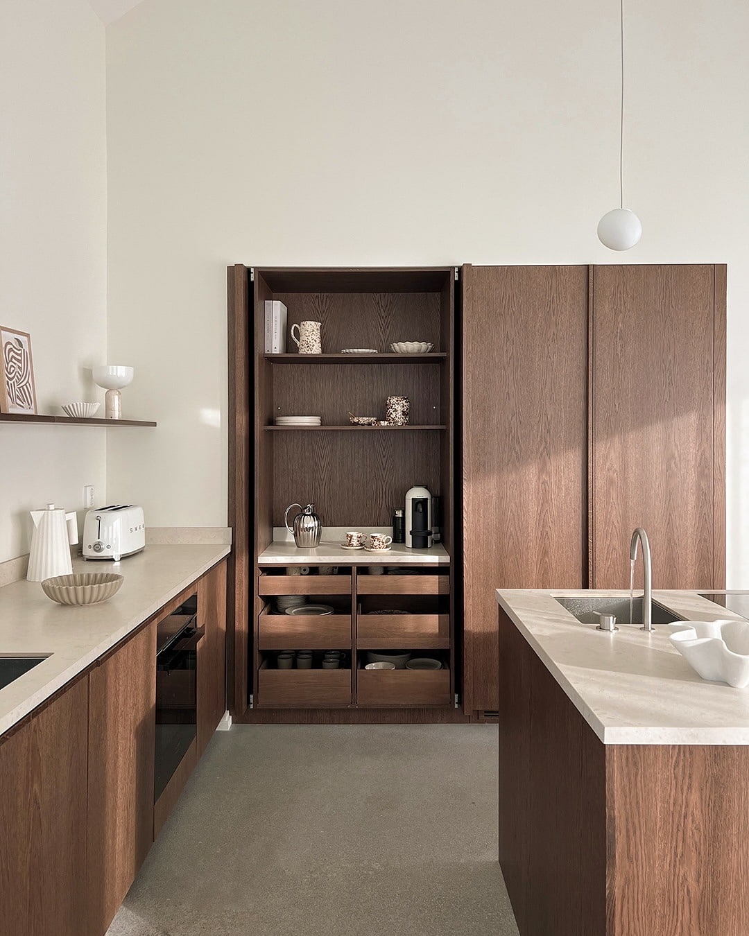 16. Dark Oak Kitchen with Integrated Storage and Neutral Stone - oak cabinets kitchen ideas