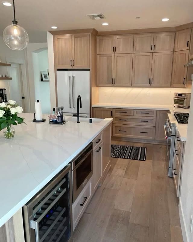 22. Light Oak Kitchen with White Counters and Black Accents - oak cabinets kitchen ideas