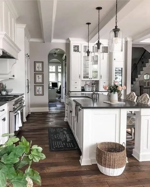 2. Classic White Farmhouse Kitchen with Refined Contrast - farmhouse kitchen ideas