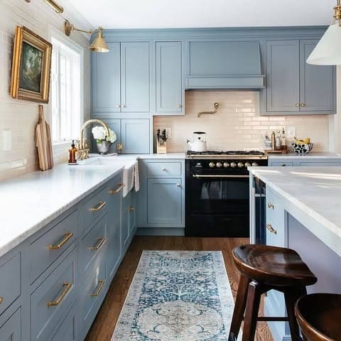 3. Soft Blue Farmhouse Kitchen with Brass Accents - farmhouse kitchen ideas