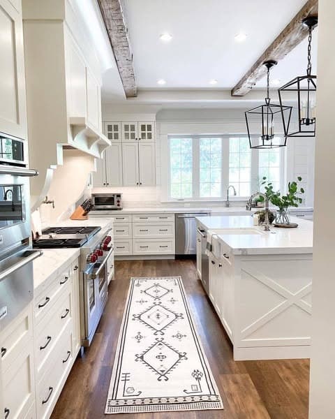 8. White Farmhouse Kitchen with Statement Lighting and Texture - farmhouse kitchen ideas