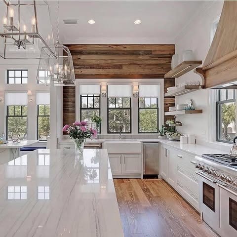 16. White Farmhouse Kitchen with Warm Wood Feature Wall - farmhouse kitchen ideas