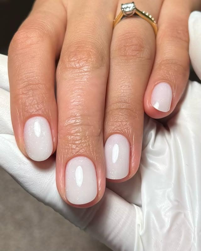 22. Milky White Short Oval Nails with Fine Shimmer - white short nail ideas
