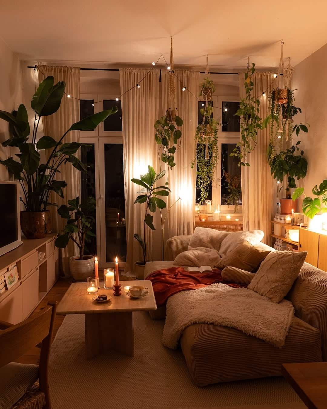 13. Cozy Evening Living with Warm Neutrals and Greenery - warm and cozy living room ideas