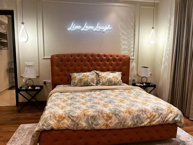 2. Tan and Caramel Upholstery with Statement Lighting - tan bedroom ideas