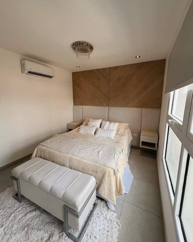 15. Modern Tan Bedroom with Chevron Wood Accent Wall - tan bedroom ideas