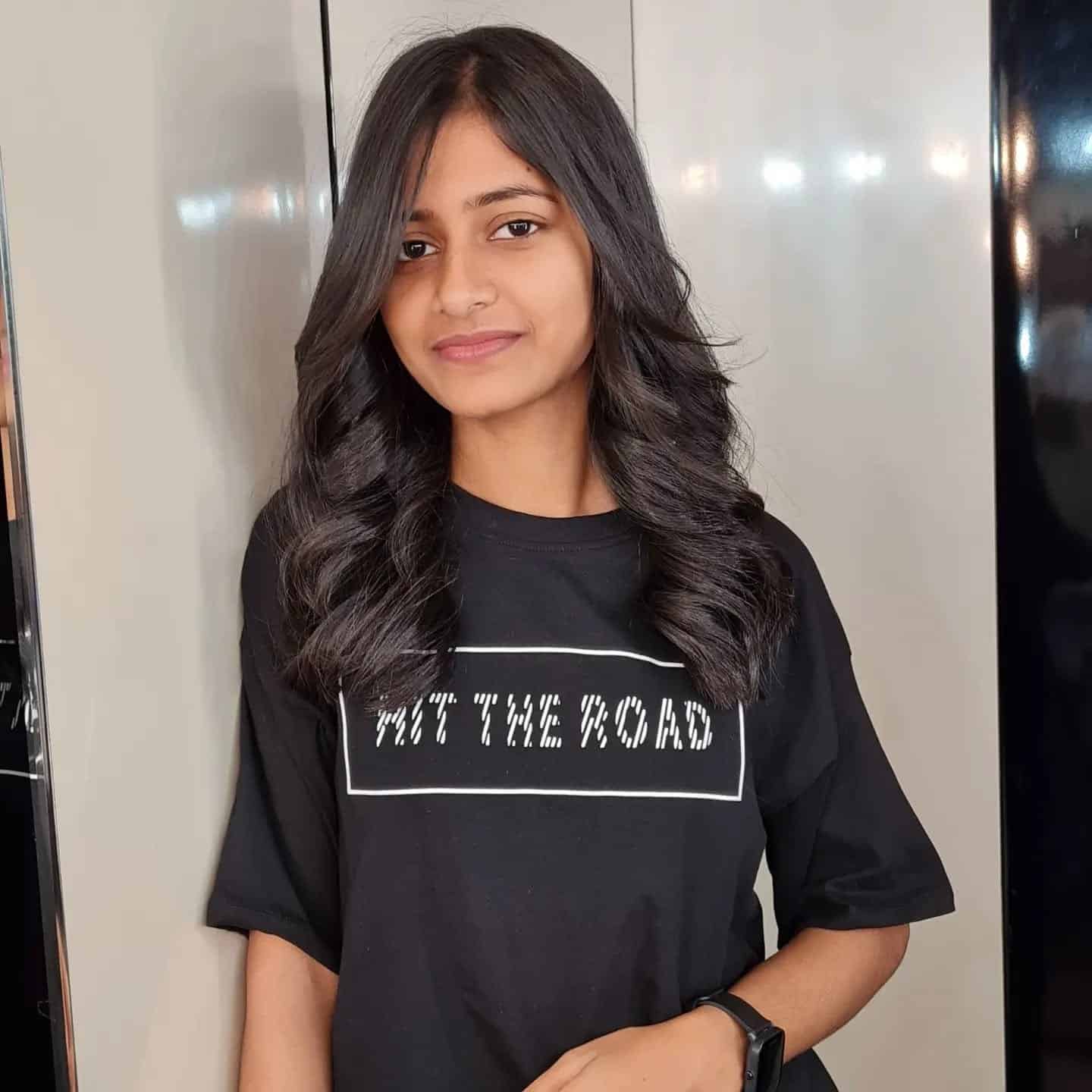 6. Layered Curls with Natural Black - Medium-Length Hairstyles