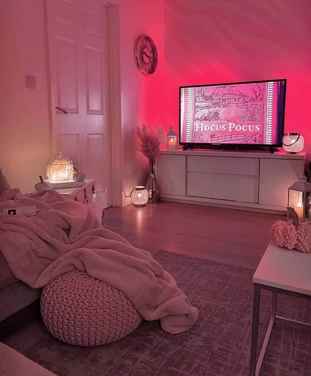 14. Moody Pink Media Room with Ambient Lighting - pink living room ideas