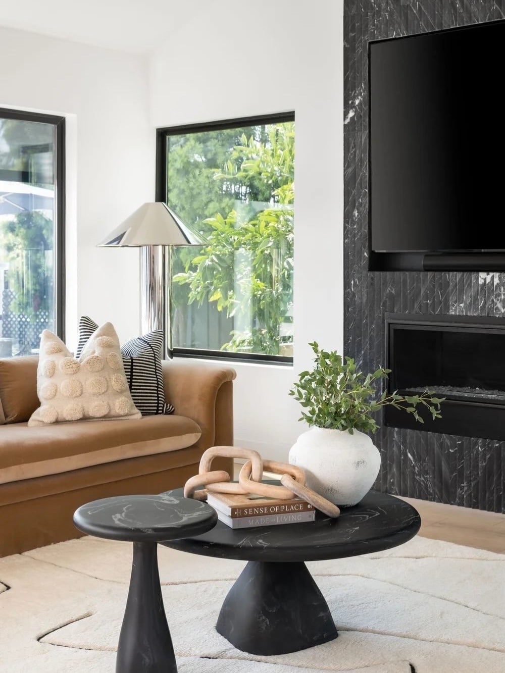 3. Soft Modern Living Room with Black Stone and Camel Leather - black and brown living room ideas