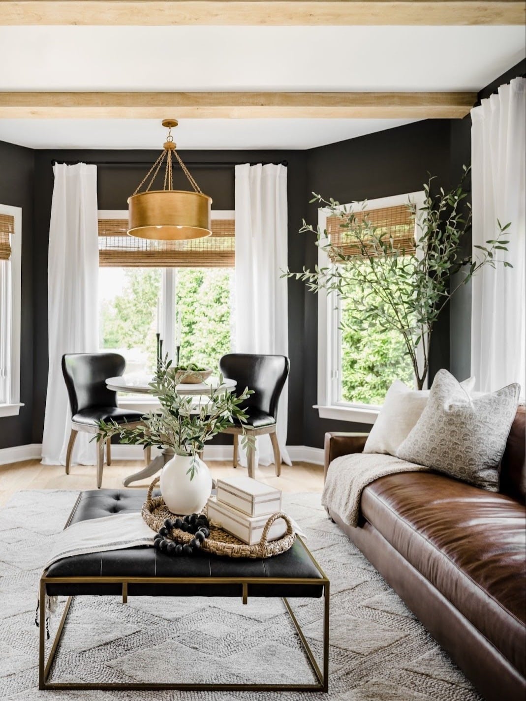 4. Black Accent Walls with Warm Brown Leather - black and brown living room ideas