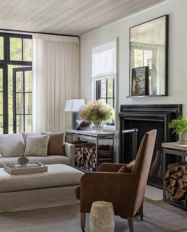 20. Soft Transitional Living Room with Black Fireplace and Brown Accents - black and brown living room ideas