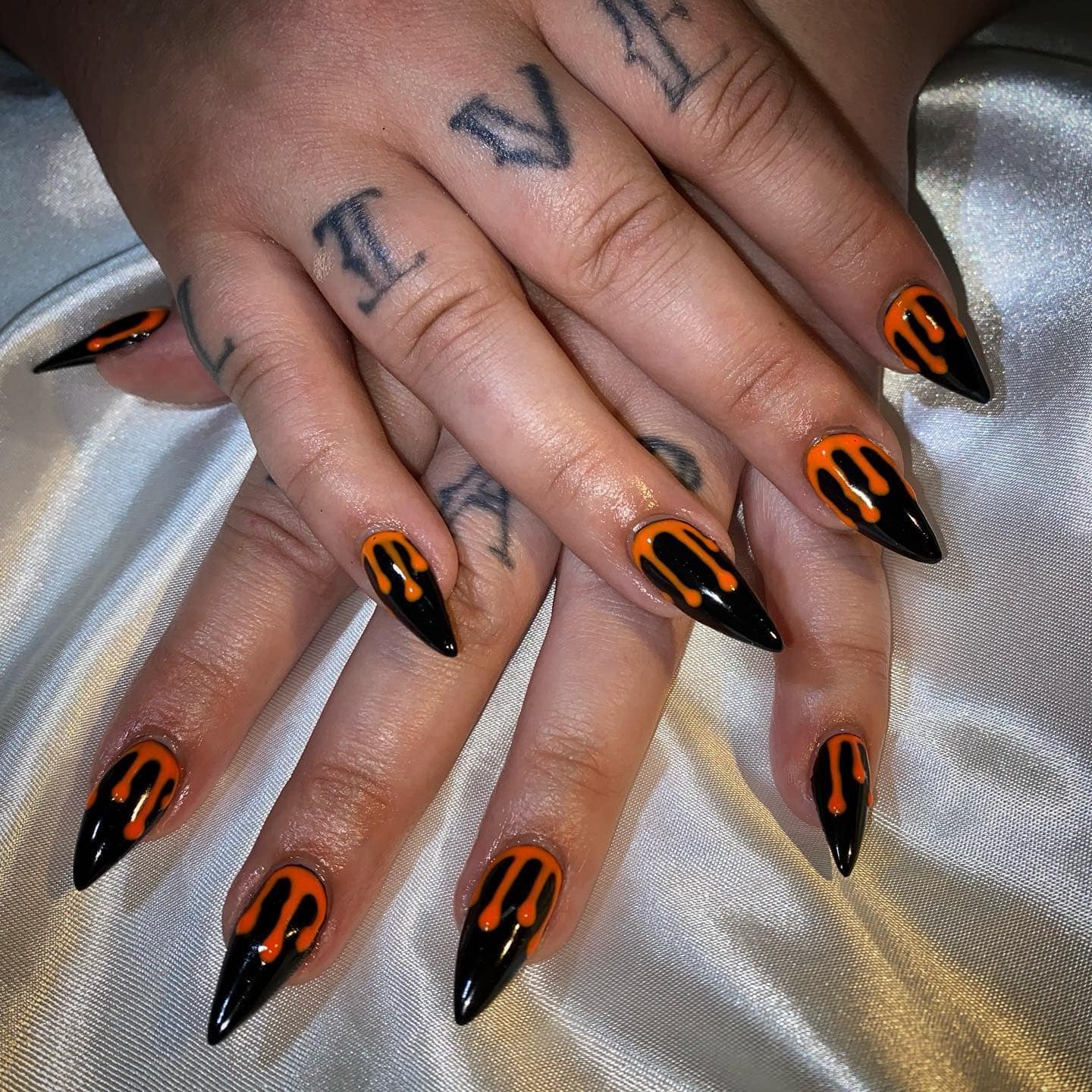 2. Black and Orange Drip Stiletto Nails - black and orange nail ideas