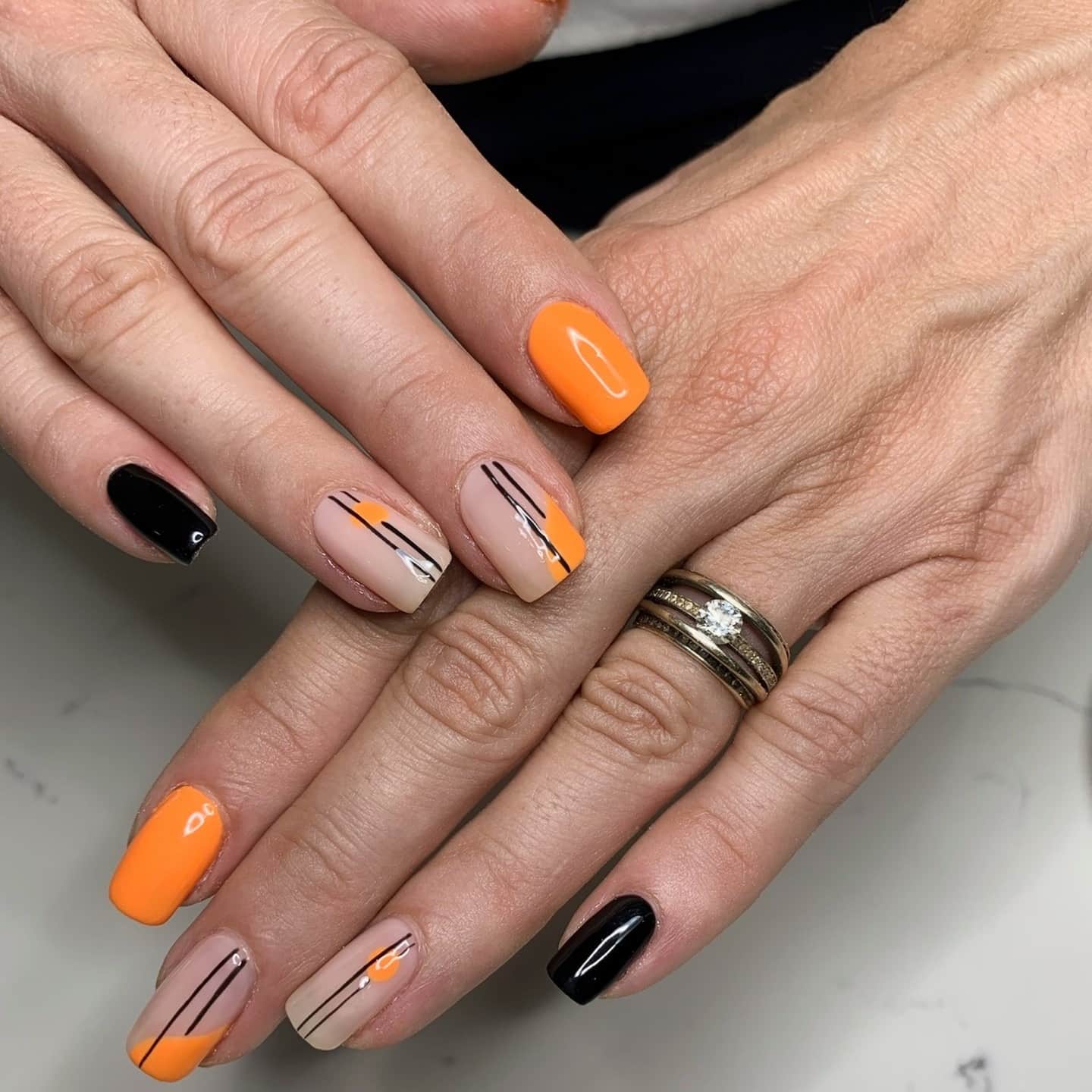4. Minimal Nude, Black, and Orange Line Art Nails - black and orange nail ideas