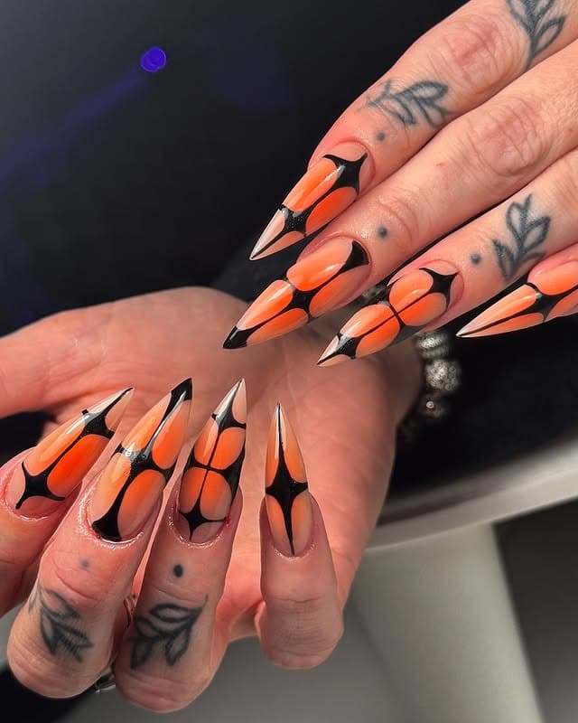 12. Black and Orange Graphic Stiletto Nails - black and orange nail ideas