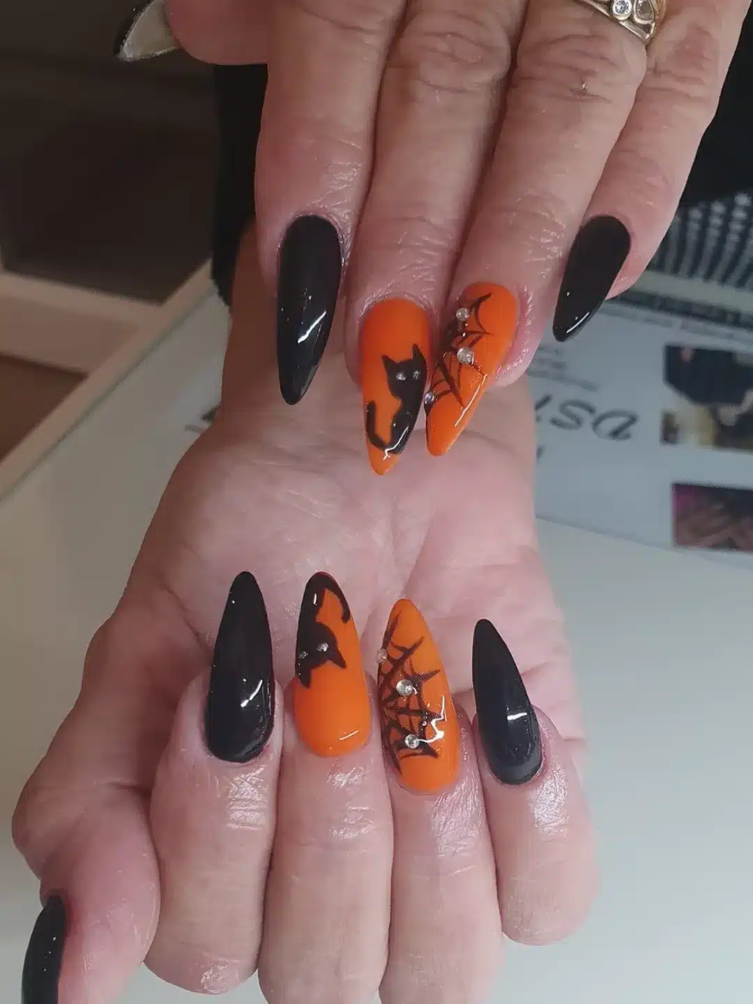 13. Black Cat and Spiderweb Almond Nails in Orange - black and orange nail ideas