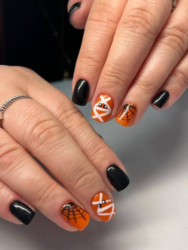15. Short Black and Orange Halloween Character Nails - black and orange nail ideas